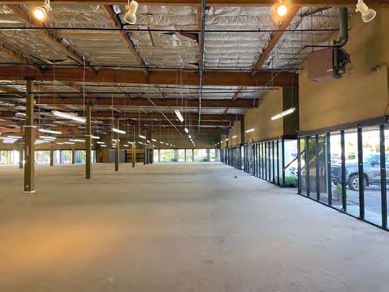 Vacant warehouse interior with glassline and exposed roof structure
