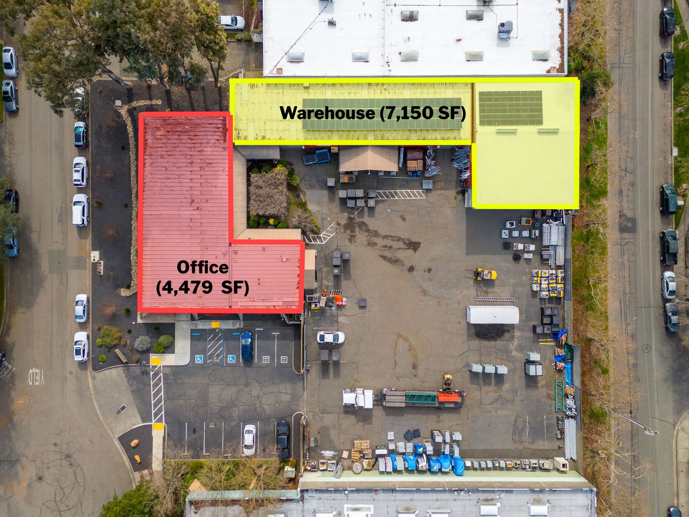 Overhead aerial marking a 4,479 SF office wing and a 7,150 SF warehouse around a paved yard